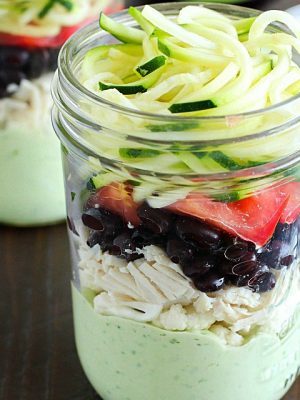 Avocado dressing (southwest style!) is nestled on the bottom of this delicious mason jar salad with zucchini noodles on the top and chicken, veggies and black beans tucked in the middle. A delicious and healthy low-carb, low-sugar lunch prepared ahead of time and eaten on-the-go! Plus a HUGE Blendtec Giveaway you won't want to miss!!