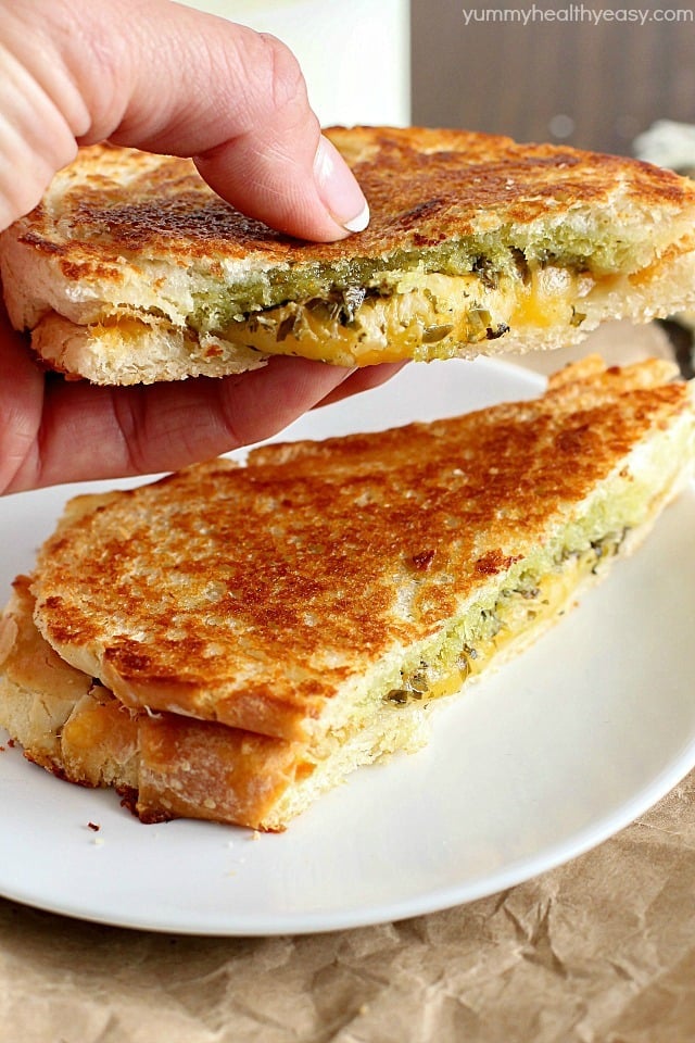 Pesto Grilled Cheese Panini is the easiest and tastiest grilled cheese sandwich pressed with two pans to make it a panini! You only need a few ingredients for this delicious sandwich full of flavor!