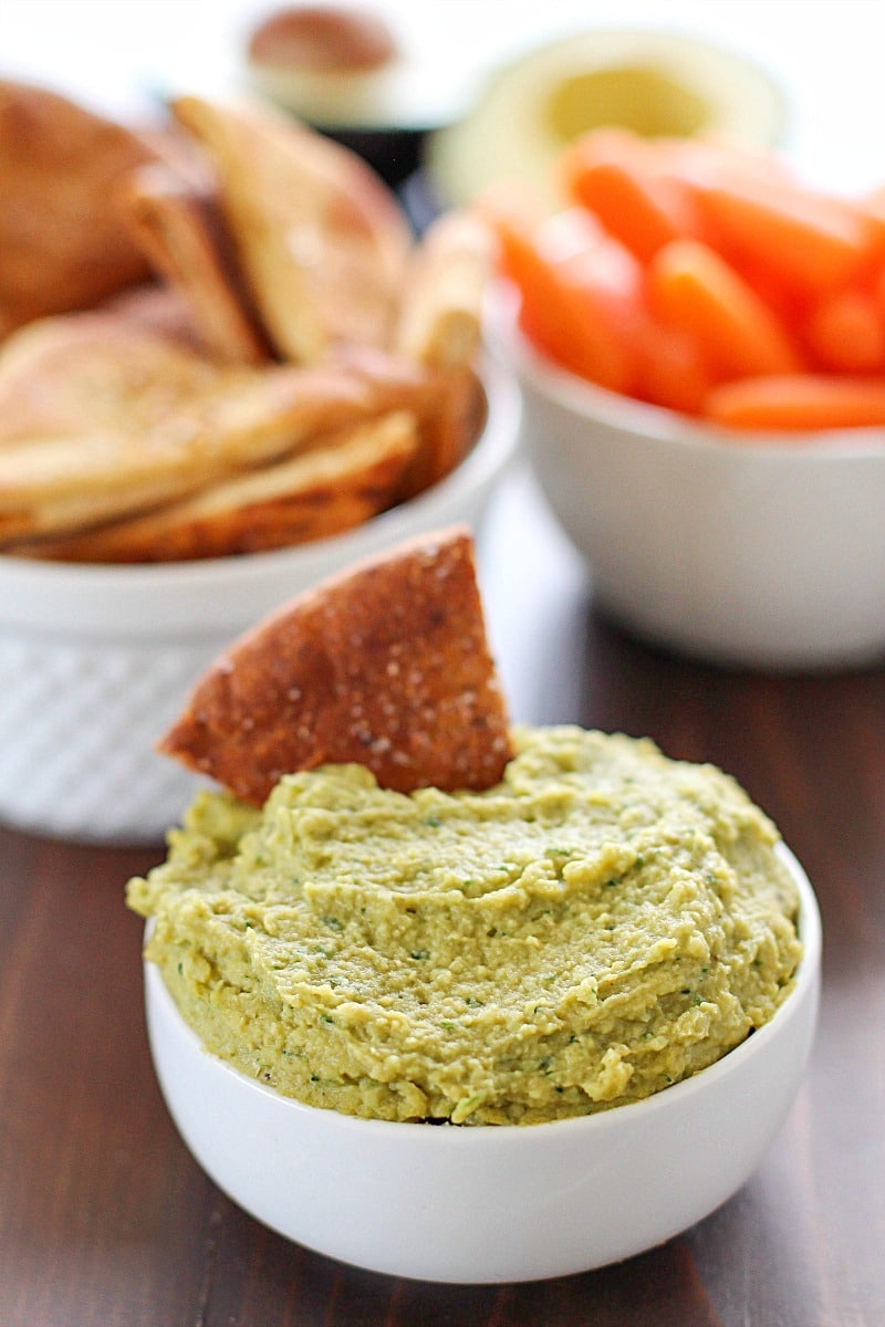 Avocado Hummus with Homemade Pita Chips - you will go crazy for the combo of avocado, garbanzo beans and spices! Dip in some easy homemade pita chips, and you have yourself a healthy, flavorful snack! 