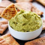 Avocado Hummus with Homemade Pita Chips - you will go crazy for the combo of avocado, garbanzo beans and spices! Dip in some easy homemade pita chips, and you have yourself a healthy, flavorful snack!