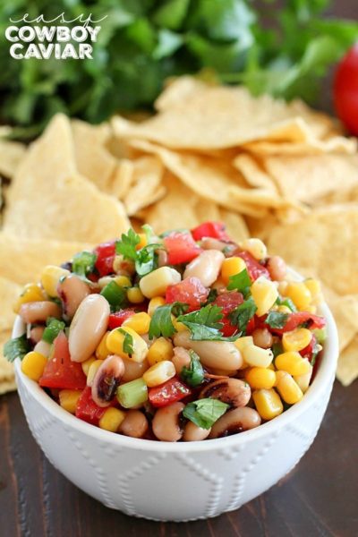 A white bowl is filled with colorful Cowboy Caviar - 43 Healthy Snack Ideas