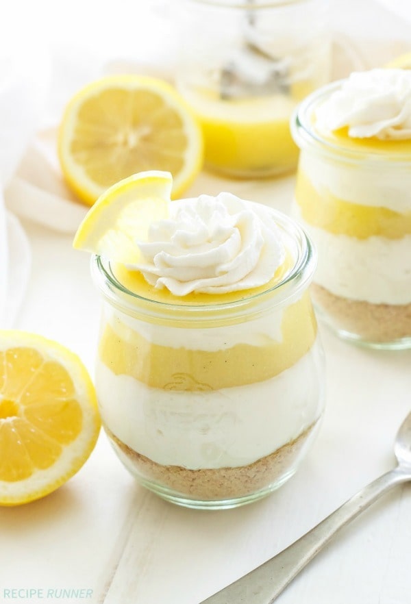 Layers of graham crackers, creamy no bake vanilla cheesecake and tart lemon curd are the perfect combination of flavors in these Lemon Curd and Vanilla Cheesecake Parfaits!