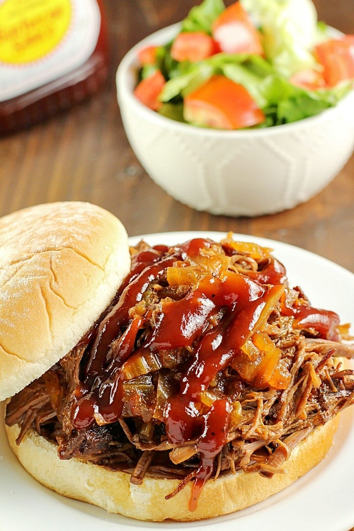 Slow Cooker Shredded Beef Sandwiches are one of my family's favorite make-ahead dinners! Cooked right in the crock pot with an easy & flavorful sauce, makes this beef roast tender and perfect for filling sandwiches/buns! Great to serve for dinner or for a party!
