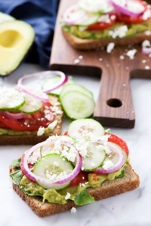 Mediterranean Avocado Toast is a spin off of my favorite veggie filled sandwich from Panera that satisfies both vegetarians and meat-lovers! A super quick and fresh, colorful sandwich – garden veggie filled guacamole, crispy cucumbers, red onions, juicy tomatoes and salty feta! 