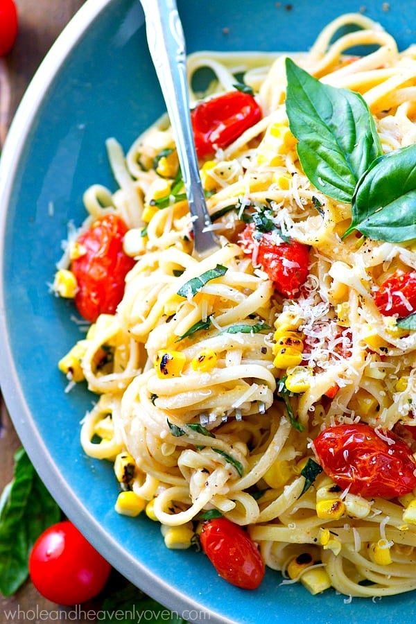 Creamy, comforting fettuccine alfredo meets summer! These luscious noodles are piled high with bursting cherry tomatoes, charred corn, and plenty of fresh Parmesan cheese.