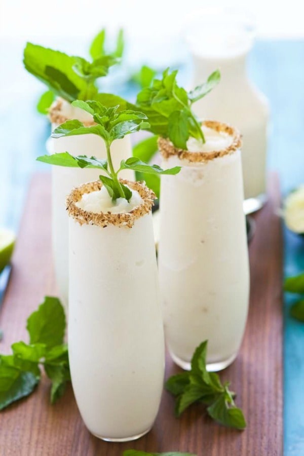 Toasted Frozen Coconut Mojito is a summer must have! Made lighter with fresh lime juice, a homemade mint simple syrup and then blended with coconut milk for a refreshing cocktail that you won’t have troubles asking for seconds!