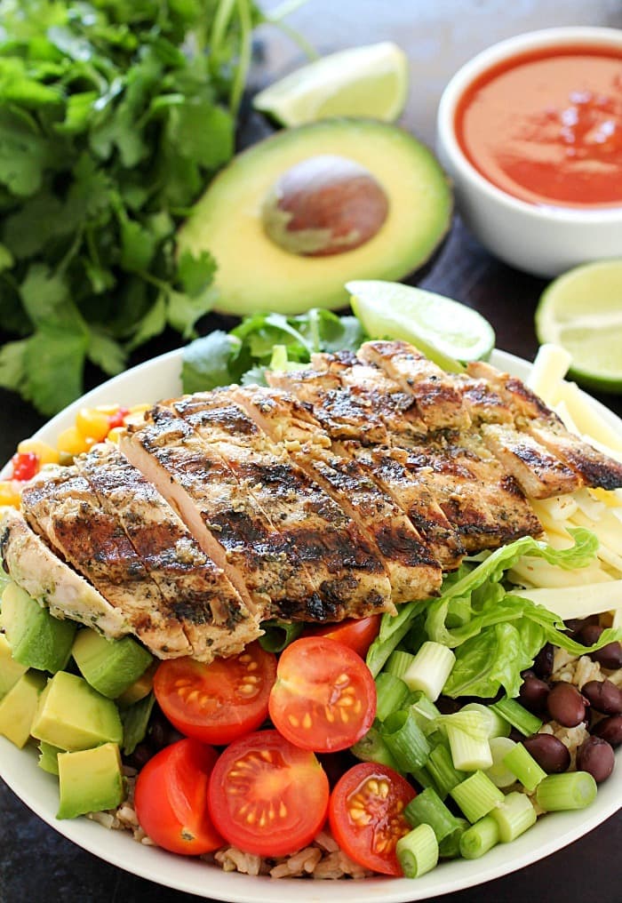 Ditch the tortilla and put everything you love about burritos into a yummy chicken burrito bowl! This recipe is so easy and adaptable to what you like. The best part of this recipe is the tender, marinated and grilled chicken! Add in any combo of brown rice, black beans, lettuce, corn, avocado, cheese, green onions, cilantro, tomatoes, salsa and a drizzling of ranch taco sauce. A fresh, delicious and healthy lunch or dinner!
