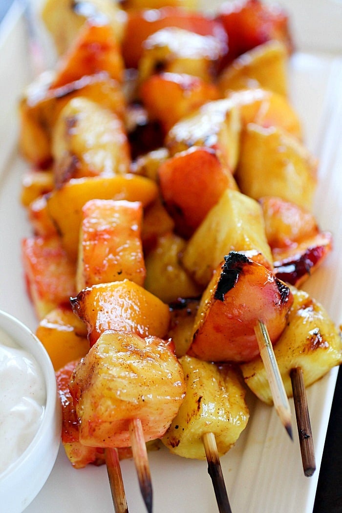 Fruit Skewers are grilled with a sweet cinnamon glaze and dipped in a delicious easy yogurt dip! You will go crazy for these grilled fruit skewers! AD