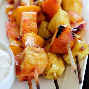 Fruit Skewers are grilled with a sweet cinnamon glaze and dipped in a delicious easy yogurt dip! You will go crazy for these grilled fruit skewers! AD