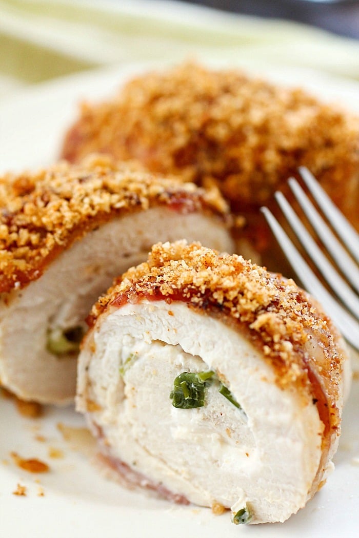 Bacon Wrapped Cream Cheese Chicken Rollups are easy to make and are packed with flavor! Cream cheese and green onions are spread over chicken cutlets and wrapped in bacon and baked then topped with bread crumbs. This is a dish everyone will rave over! Plus 22 more delicious bacon recipes for you to drool over. You're welcome! ;)