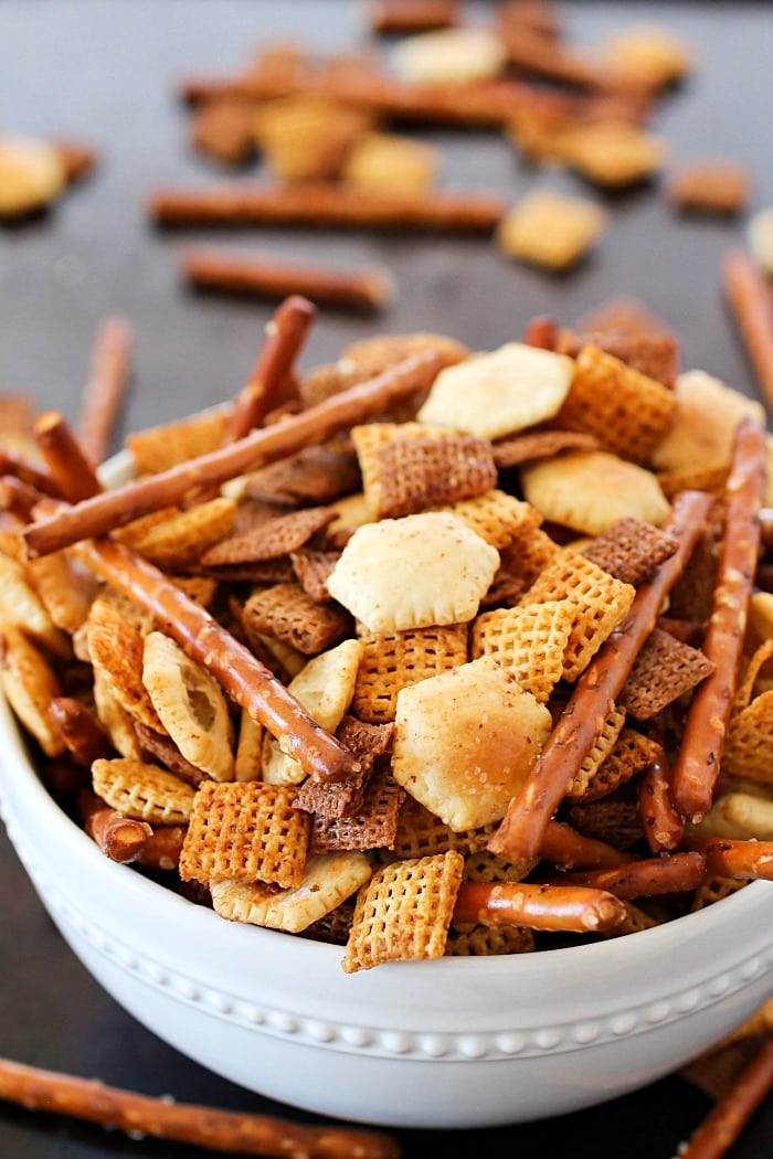 This Homemade Snack Mix Recipe is so easy to make and tastes delicious! Cereal, crackers and pretzels are tossed with a little butter and seasonings, then baked. Perfect to serve at a party or to munch on when you're watching the game. :)