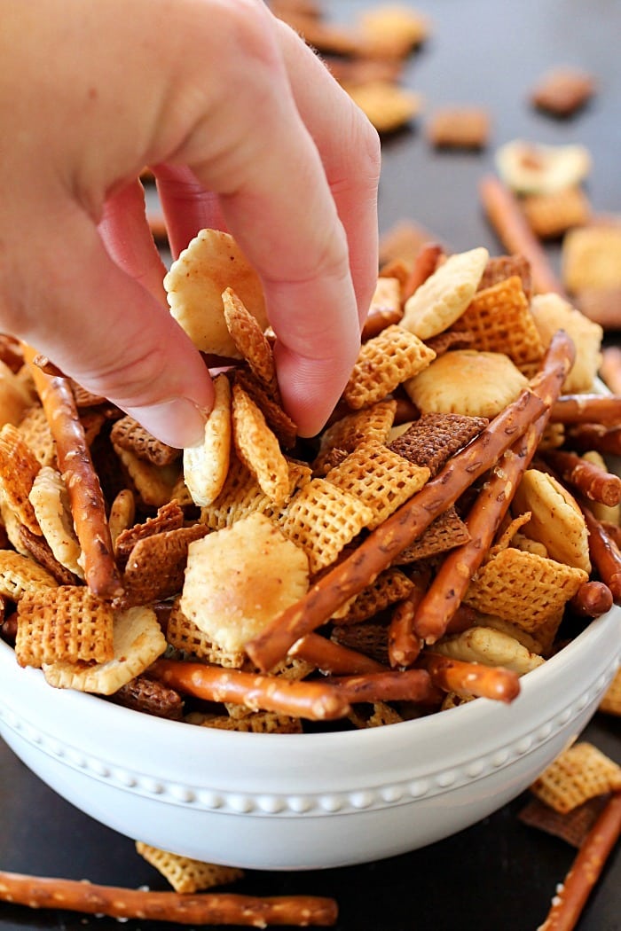 This Homemade Snack Mix Recipe is so easy to make and tastes delicious! Cereal, crackers and pretzels are tossed with a little butter and seasonings, then baked. Perfect to serve at a party or to munch on when you're watching the game. :)