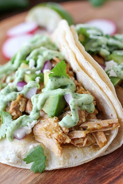 Pork Verde Tacos cooked in the crock pot and served with a drizzle of amazing jalapeño sauce. You will love the flavor in these pork tacos and love how easy they are to make! AD
