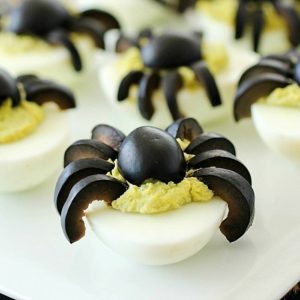 Celebrate Halloween with Spooky Spider Avocado Deviled Eggs! Your party guests will love these creepy crawly olive spiders on top of ghoulishly green avocado deviled eggs! AD