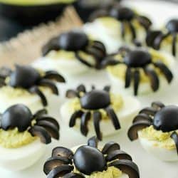 Celebrate Halloween with Spooky Spider Avocado Deviled Eggs! Your party guests will love these creepy crawly olive spiders on top of ghoulishly green avocado deviled eggs!