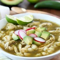 This Chicken Posole Verde Recipe has shredded chicken and tender hominy in a crazy flavorful verde broth! Such wonderful flavor in the verde sauce, you won't even believe it! This soup is best served with radishes, cilantro, avocado, queso fresco and/or tortilla chips. (Skip the chips to keep this gluten free!) AD