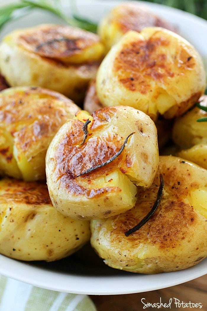 Smashed Potatoes (also known as Potatoes Fondantes) are seriously the best potatoes you will ever eat!! They're boiled in chicken stock and rosemary until tender and then smashed down and browned on each side. Crispy on the outside, tender and flavorful on the inside! Definitely a must-make side dish! AD