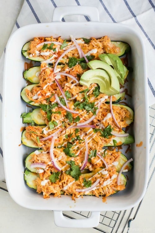 Buffalo Chicken Enchilada Zucchini Boats – tender zucchini stuffed with a creamy Buffalo Chicken mixture then drizzled with ranch. The perfect healthy way to eat Buffalo Chicken Dip without all the carbs!