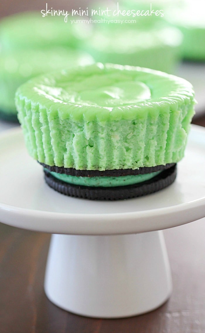 Skinny Mini Mint Cheesecakes with an Oreo crust! This lighter mint cheesecake recipe is super easy to make and you only need a few ingredients to whip up a batch. These cute cheesecakes have less calories than a regular cheesecake plus built-in portion control with the muffin size!