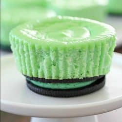 Skinny Mini Mint Cheesecakes with an Oreo crust! This lighter mint cheesecake recipe is super easy to make and you only need a few ingredients to whip up a batch. These cute cheesecakes have less calories than a regular cheesecake plus built-in portion control with the muffin size!