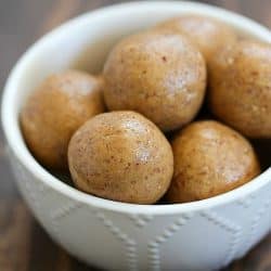 Small white bowl filled with Healthy Apple Pie Protein Balls.