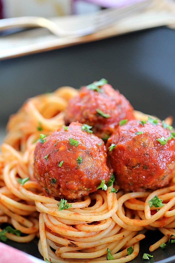 The best combo of beef and bacon - Bacon Meatballs! Flavorful, tender meatballs on a bed of cooked pasta noodles.