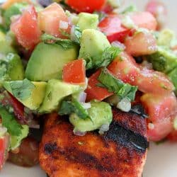 This Spicy Grilled Salmon has an easy to make, sweet/spicy rub that everyone will love! Topped with Avocado Salsa, this dinner is sure to please!