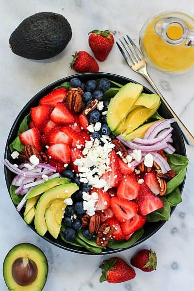 You will FLIP over this Spinach Salad Recipe! Leaves of spinach topped with berries, avocado, feta cheese, walnuts and a homemade honey-garlic vinaigrette! #ad