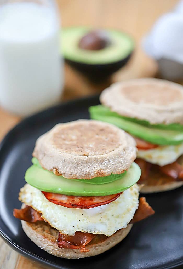 This Egg, Bacon and Avocado Breakfast Sandwich is a buttered whole wheat bun filled with crisoy bacon, canadian bacon, fried egg and avocado. So yummy! #AD