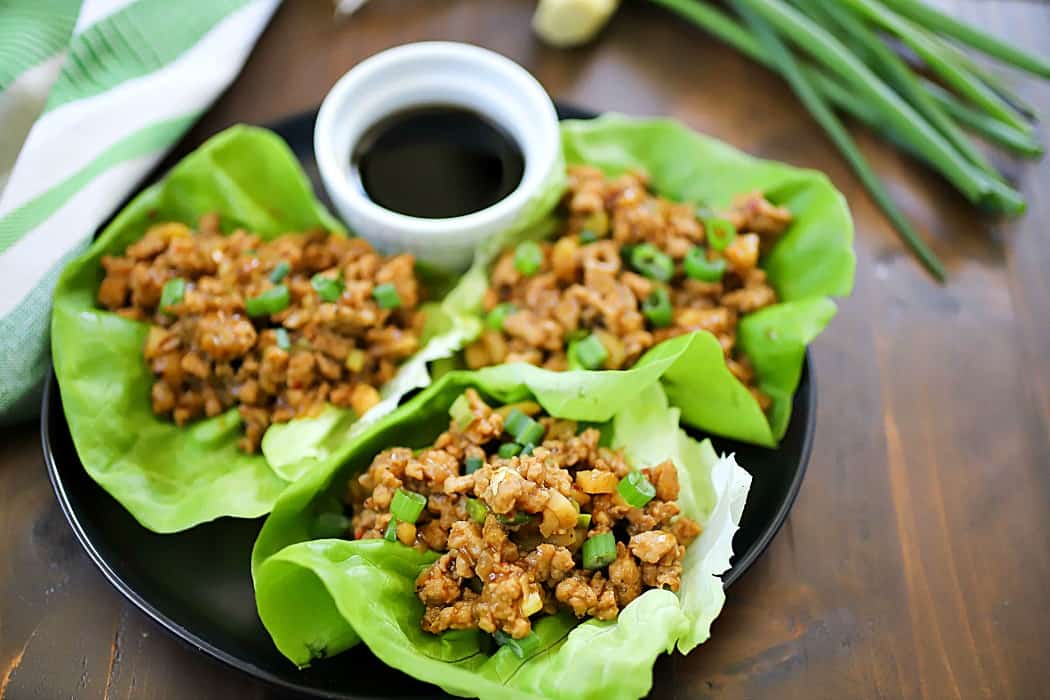 This Chicken Lettuce Wraps Recipe is seriously SO GOOD!! So much flavor in the asian inspired chicken mixture inside soft butter lettuce. Delicious!