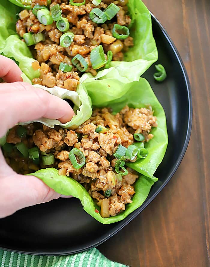This Chicken Lettuce Wraps Recipe is a low carb, flavorful appetizer or main dish! The ground chicken mixture is packed with flavor but so easy to make!