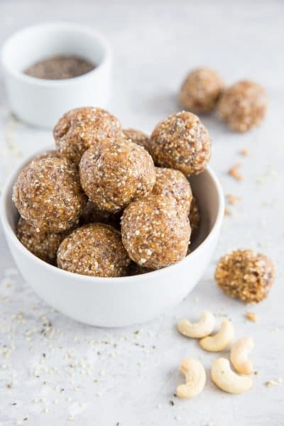 A white bowl filled with delicious looking Fig & Date Balls - 43 Healthy Snack Ideas!