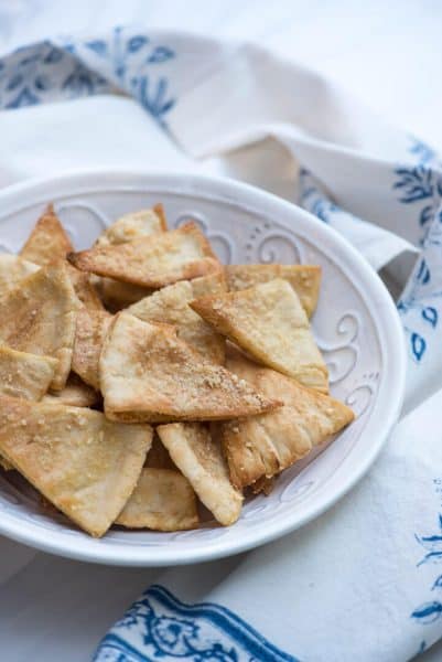 Side view of Homemade Parmesan Garlic Pita Chips in a small plate.