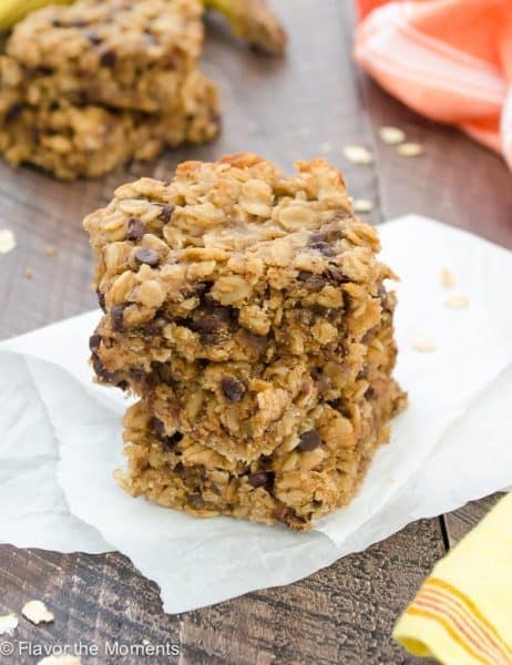 Stacked Peanut Butter Banana Chocolate Chip Oat Bars in parchment paper + 43 Healthy Snack Ideas