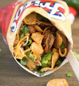 Close up of a Frito snack size bag filled with taco mixture and toppings. Yum!
