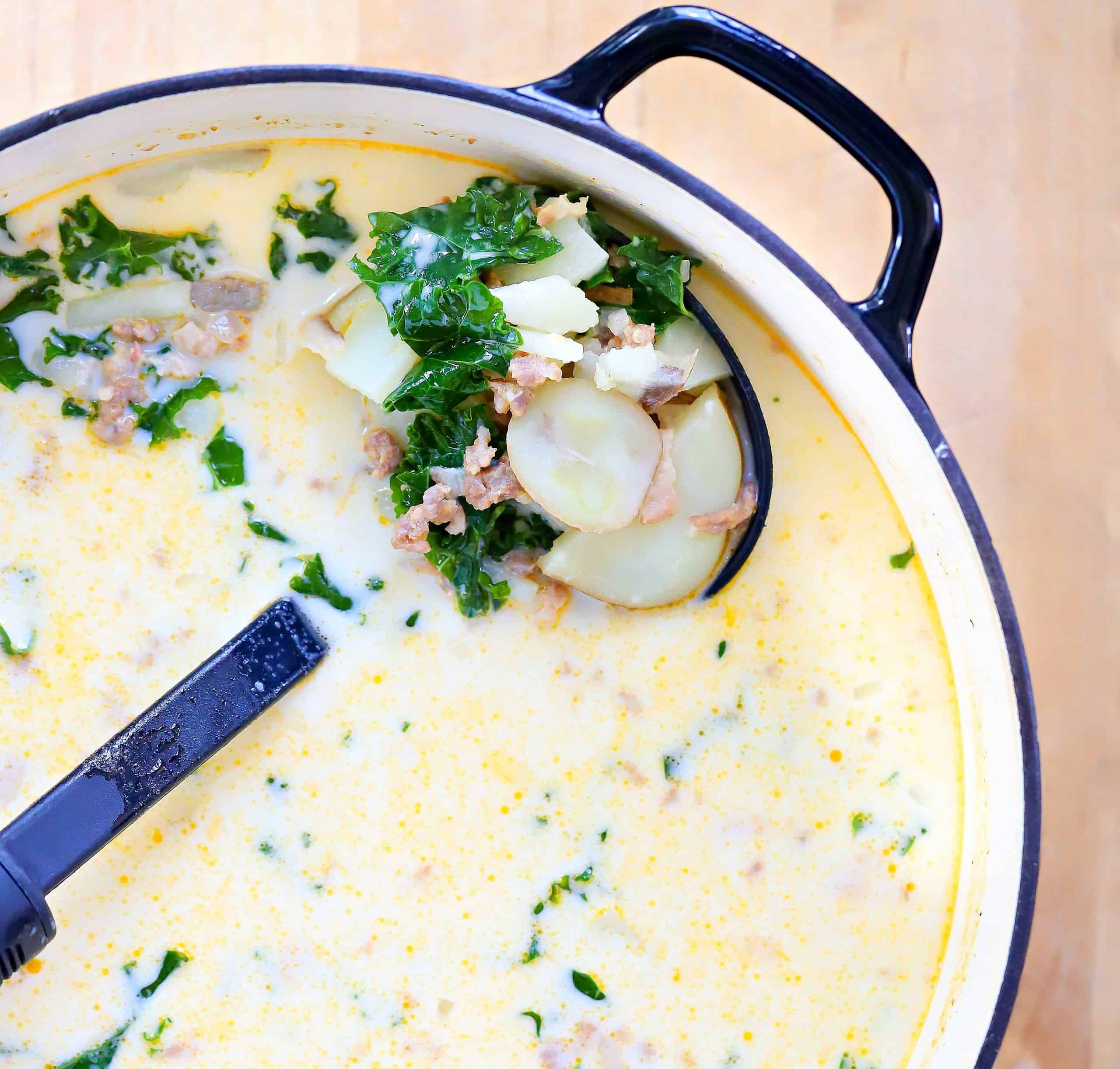 Big pot filled with Zuppa Toscana Soup with a ladle.
