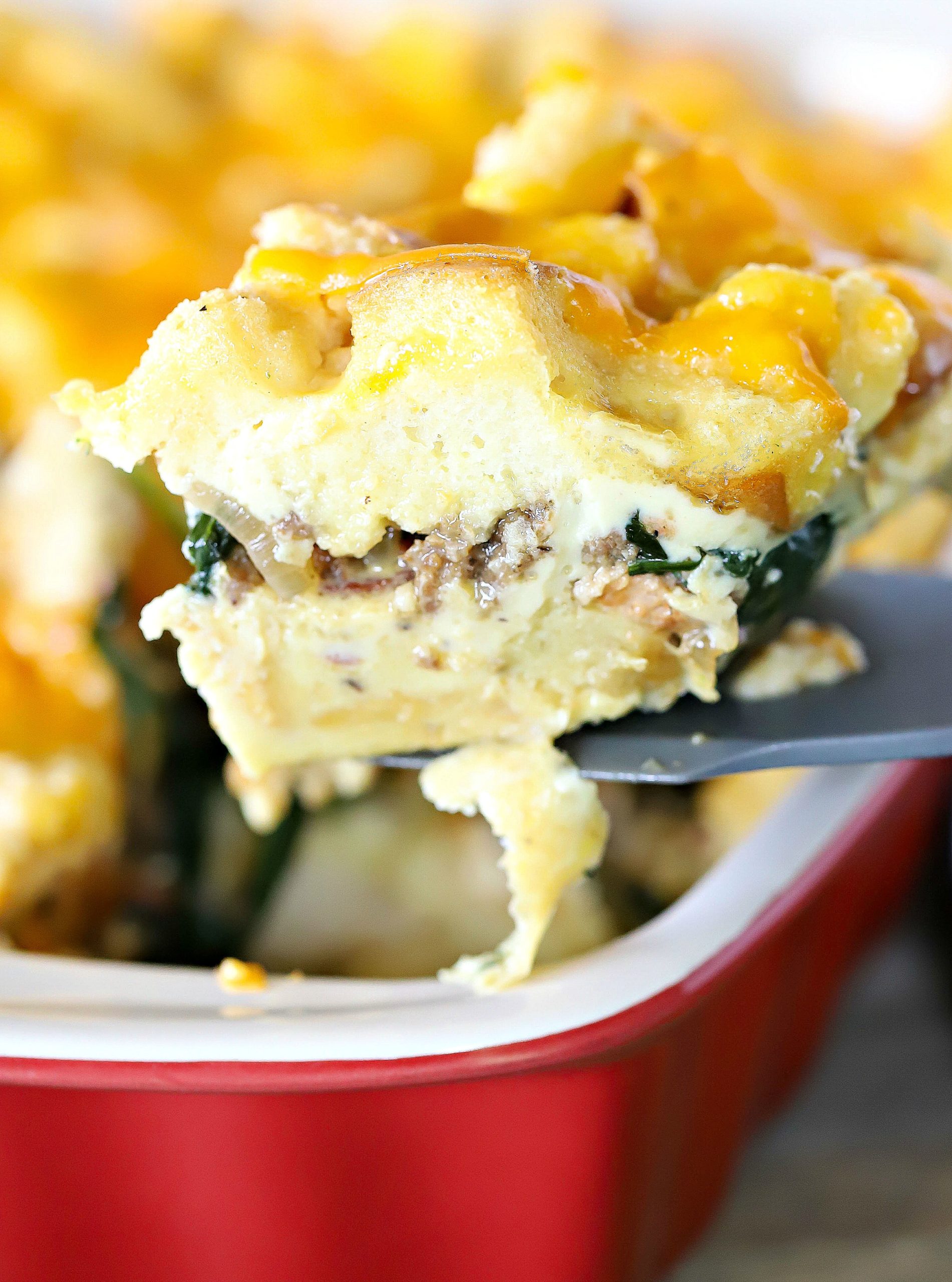 yummy slice of cheesy strata scooped from a casserole dish