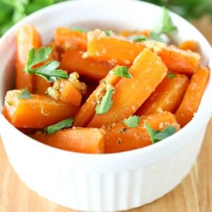 square image of a white bowl filled with glazed carrots.