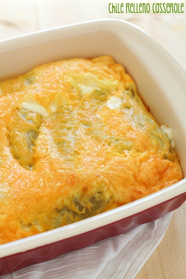 Casserole dish filled with Chile relleno casserole topped with melted cheese.
