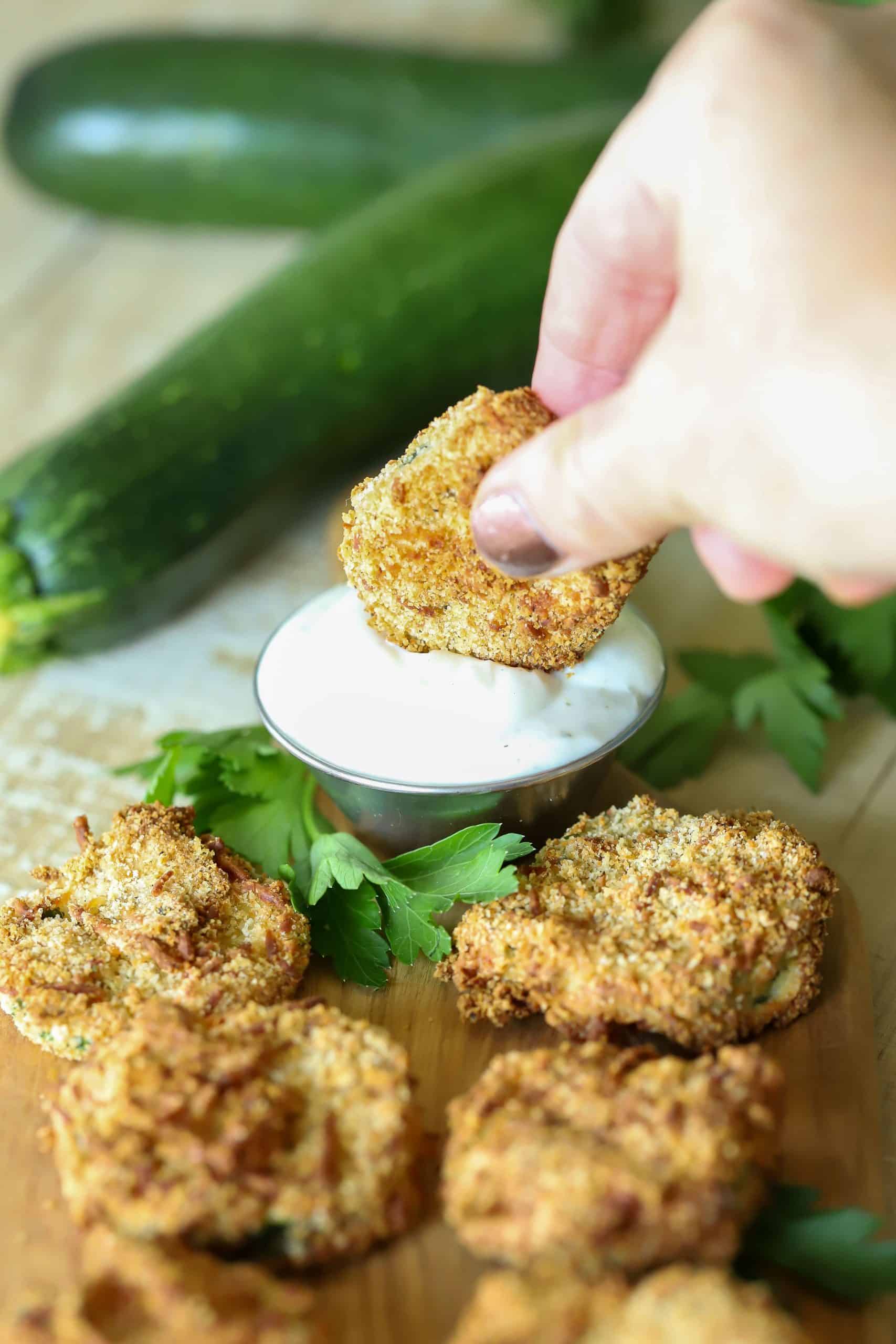 Easy Air Fryer Zucchini Chips are the perfect snack or side dish. Serve with a healthy Greek yogurt and ranch dipping sauce, and you won't stop snacking on them! #airfryer #appetizer #snack #zucchini #healthyrecipe #healthy via @jennikolaus