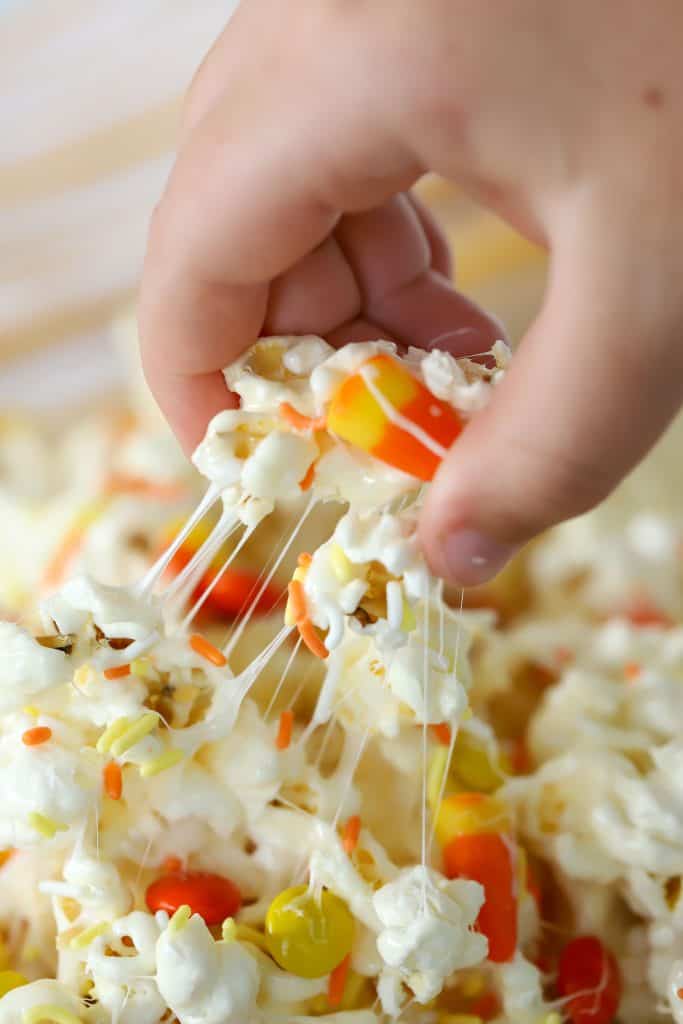 Marshmallow Popcorn Treat being pulled from a bowl